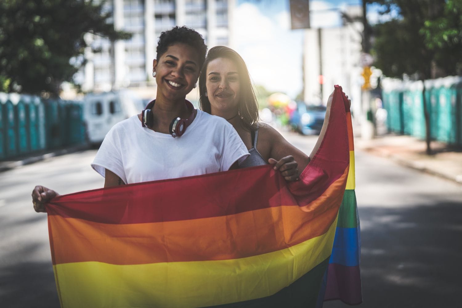 LGBT couple holding a rainbow pride flag
